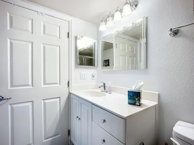a bathroom with a sink a mirror and a shower