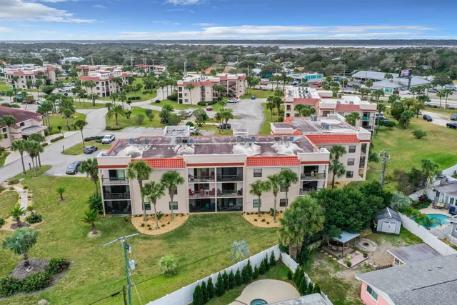 an aerial view of residential houses with outdoor space