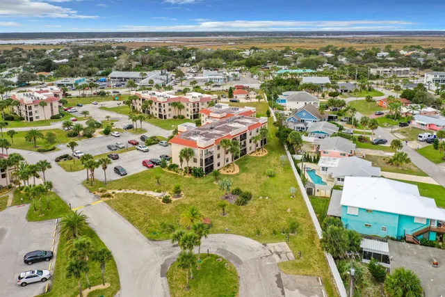 an aerial view of residential houses with outdoor space