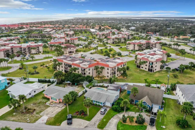 an aerial view of residential houses with outdoor space