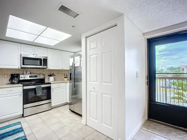 a kitchen with stainless steel appliances granite countertop a refrigerator and a stove top oven