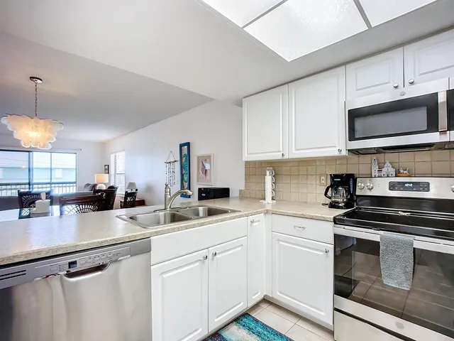 a kitchen with appliances a sink and cabinets
