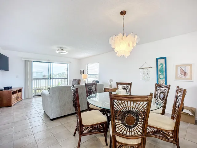 a dining room with furniture a rug and a chandelier