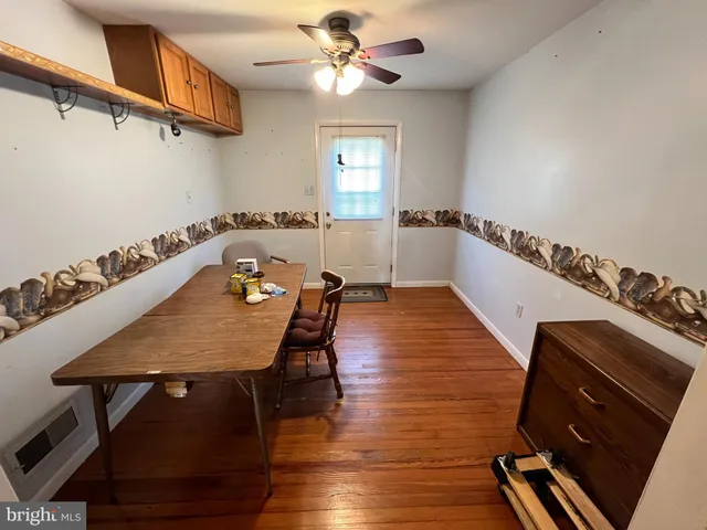 a dining room with furniture and window