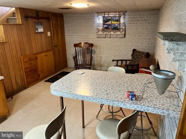 a bathroom with a granite countertop sink a toilet and a mirror