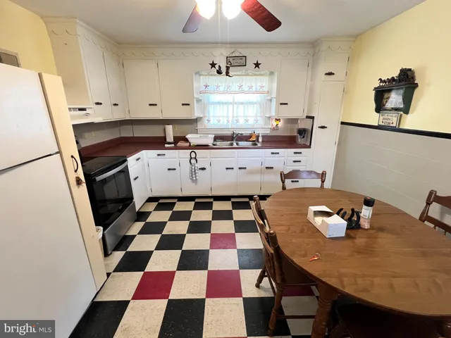 a kitchen with a sink a stove a rug and a cabinets