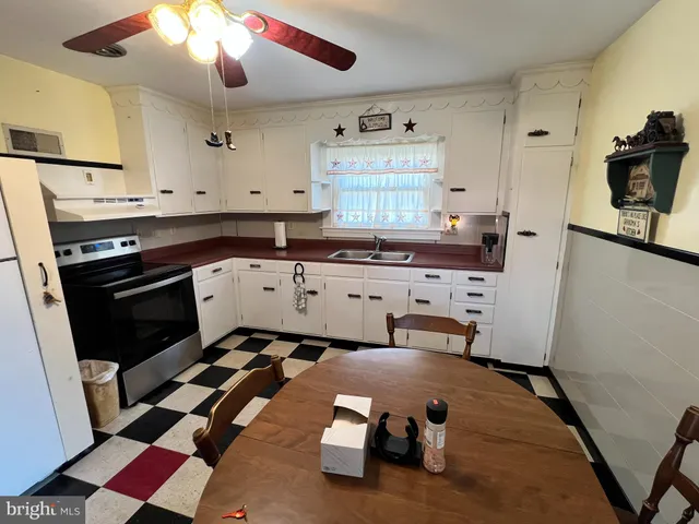 a kitchen with a sink stove and cabinets