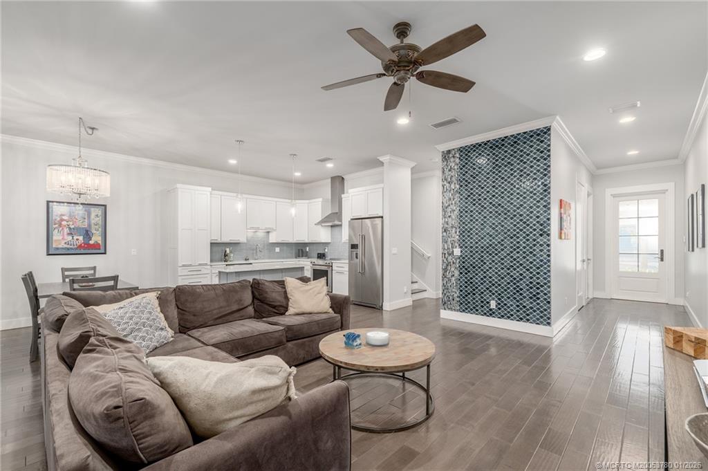 411 Southeast High School Avenue Stuart, FL 34994 - Photo 1 of 37 a living room with furniture and a large window