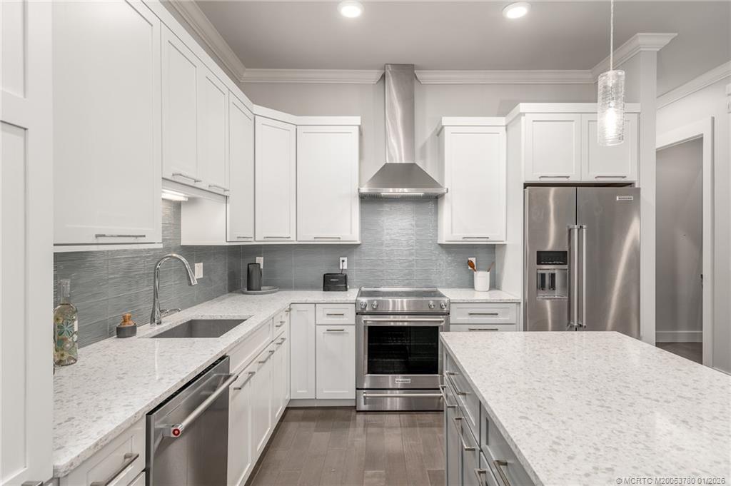 411 Southeast High School Avenue Stuart, FL 34994 - Photo 11 of 37 a kitchen with a sink stove and refrigerator