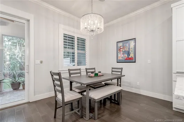 a view of a dining room with furniture wooden floor and a chandelier