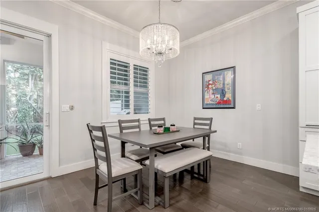 a view of a dining room with furniture wooden floor and a chandelier