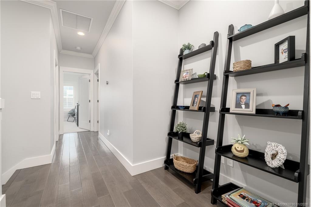 411 Southeast High School Avenue Stuart, FL 34994 - Photo 18 of 37 a room with lots of white furniture and wooden floor