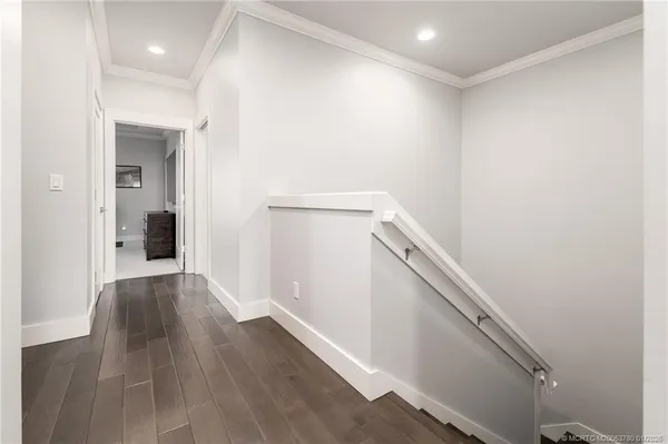 a view of a hallway with wooden floor