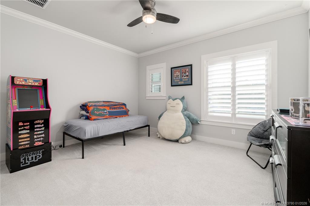 411 Southeast High School Avenue Stuart, FL 34994 - Photo 20 of 37 a bedroom with furniture and a window