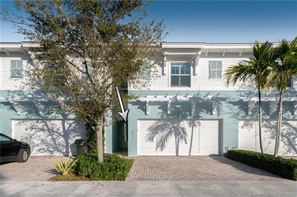 411 Southeast High School Avenue Stuart, FL 34994 - Photo 28 of 37 a front view of a house with a yard