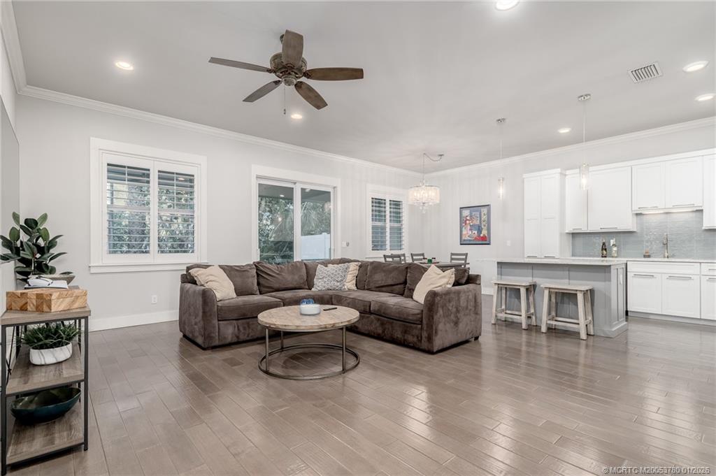 411 Southeast High School Avenue Stuart, FL 34994 - Photo 4 of 37 a living room with furniture and a large window