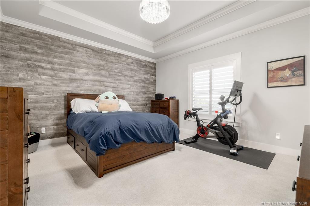 411 Southeast High School Avenue Stuart, FL 34994 - Photo 5 of 37 a bedroom with bed and a couch