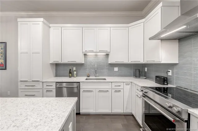 a kitchen with white cabinets and white appliances