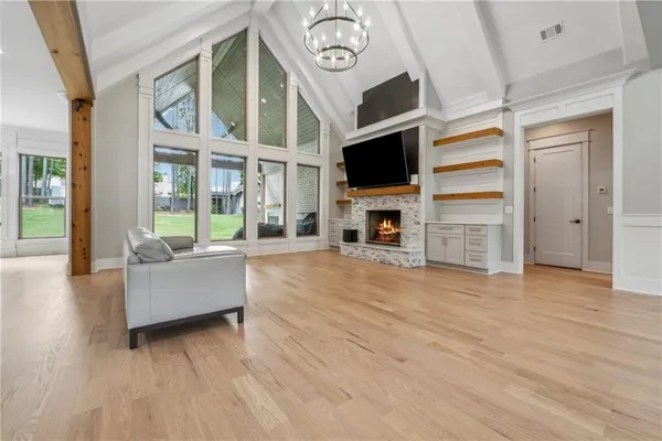 a dining hall with stainless steel appliances kitchen island granite countertop a table chairs and a refrigerator