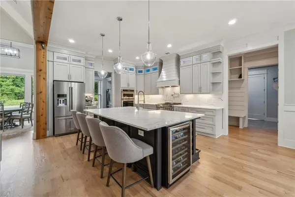 a large kitchen with stainless steel appliances lots of counter space and windows