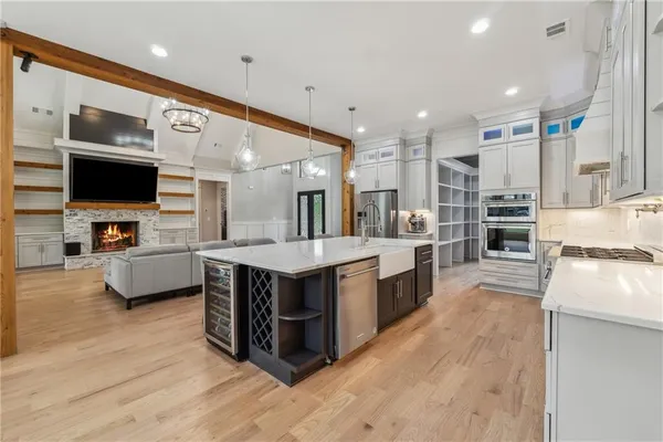 a large kitchen with kitchen island a sink a counter space and stainless steel appliances