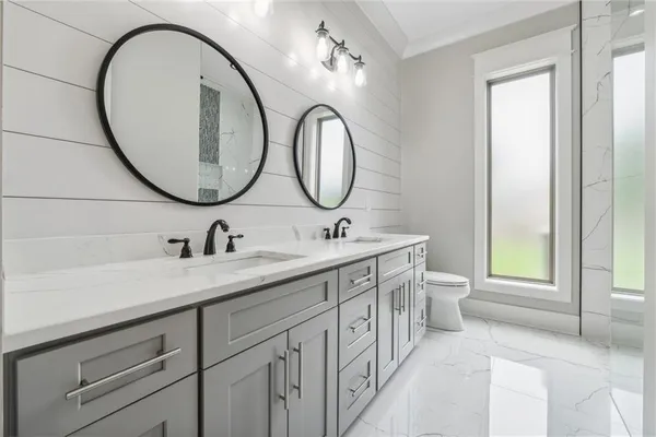 a spacious bedroom with a bed and a dresser