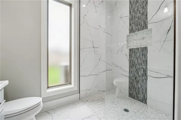 a spacious bedroom with a bed and a dresser