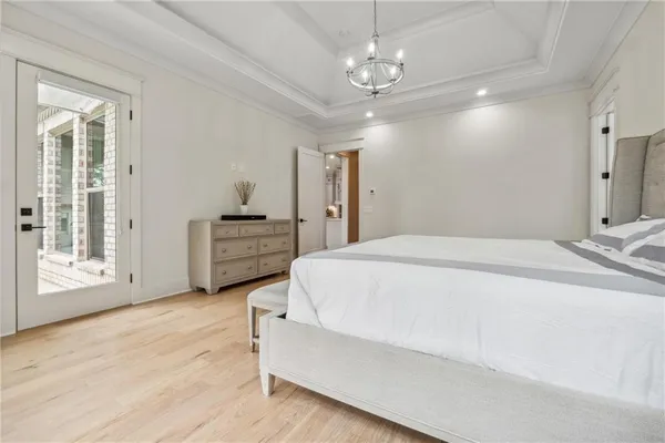 an empty room with wooden floor and a ceiling fan