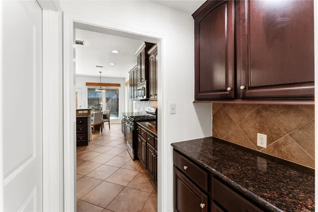 a kitchen with a stove and a refrigerator