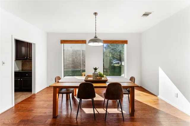a view of a dining room with furniture window and wooden floor