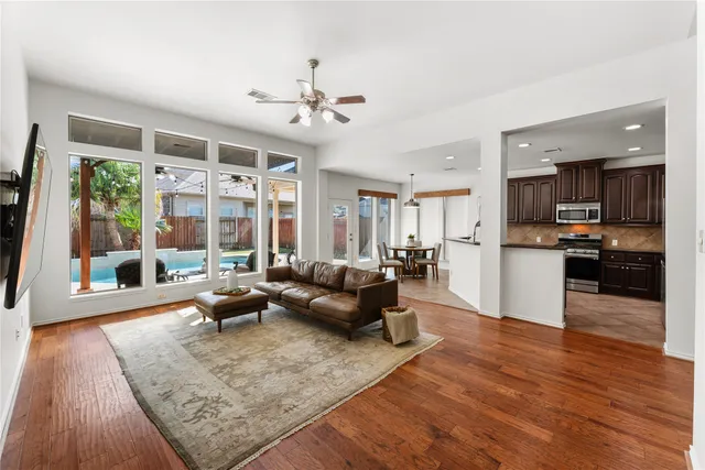 a living room with furniture and wooden floor