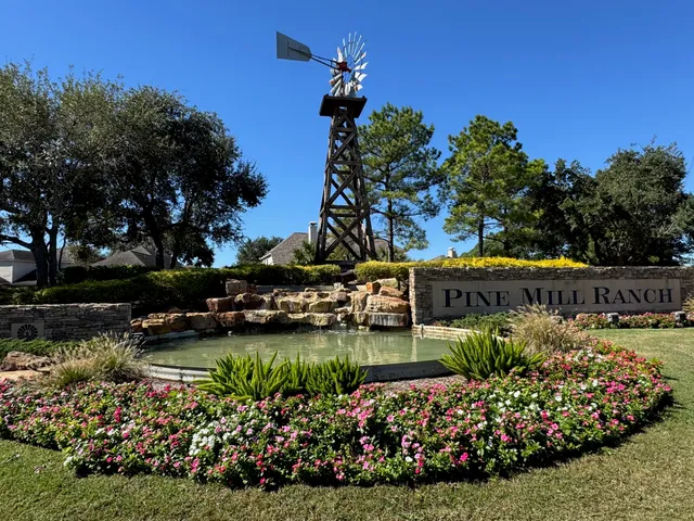 a view of a house with a big yard and potted plants