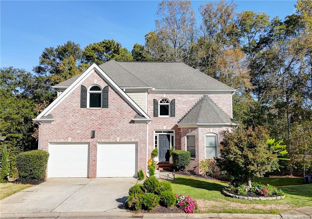 3064 Montclair Circle Southeast Smyrna, GA 30080 - Photo 1 of 48 a front view of a house with a yard and garage