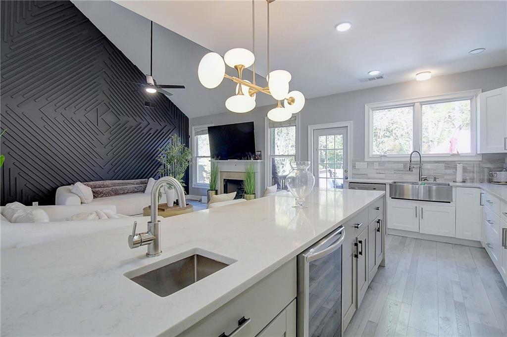 3064 Montclair Circle Southeast Smyrna, GA 30080 - Photo 12 of 48 a kitchen with cabinets a sink stainless steel appliances and a fireplace