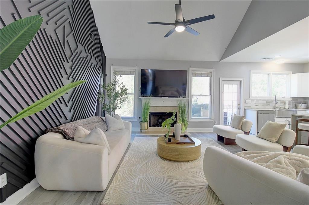 3064 Montclair Circle Southeast Smyrna, GA 30080 - Photo 13 of 48 a living room with furniture a fireplace and a flat screen tv