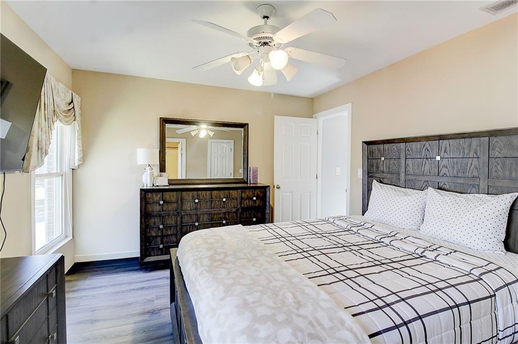 3064 Montclair Circle Southeast Smyrna, GA 30080 - Photo 33 of 48 a bedroom with a bed and a chandelier