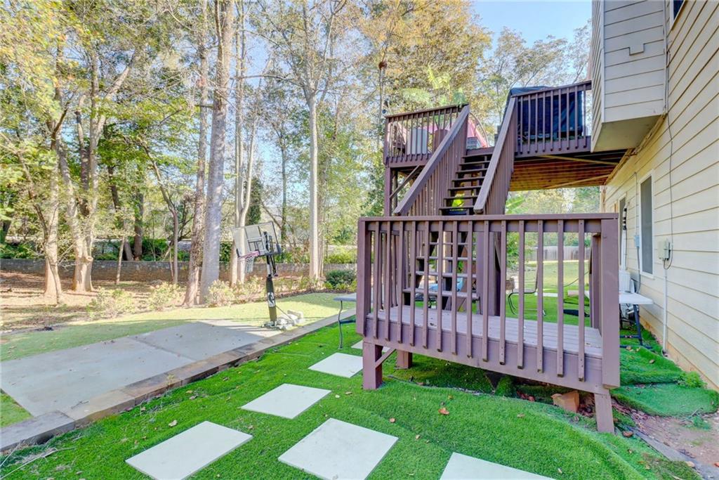 3064 Montclair Circle Southeast Smyrna, GA 30080 - Photo 45 of 48 a view of a deck with a big yard and large trees