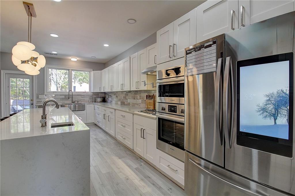 3064 Montclair Circle Southeast Smyrna, GA 30080 - Photo 10 of 48 a kitchen with stainless steel appliances granite countertop a refrigerator a sink dishwasher a stove and white countertops with wooden floor
