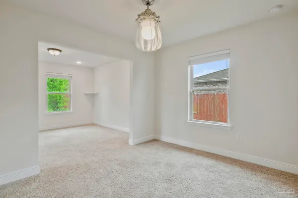 an empty room with windows and entrance