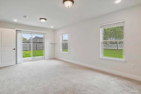 an empty room with windows and closet