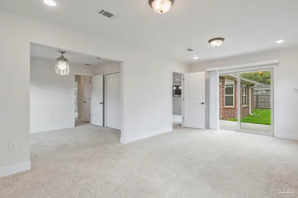 an empty room with floor to ceiling window and windows