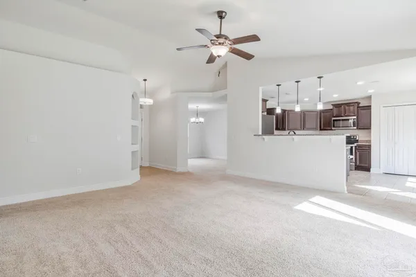 a view of a kitchen with a sink and a refrigerator