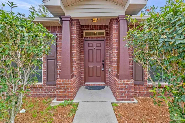 front view of a brick house with a large windows