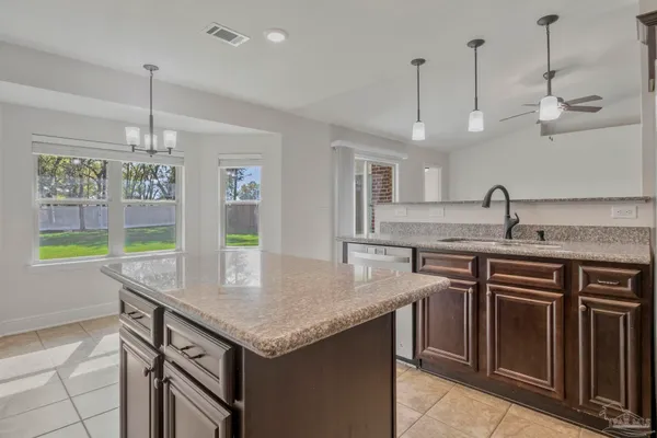 a kitchen with kitchen island granite countertop a sink and center island