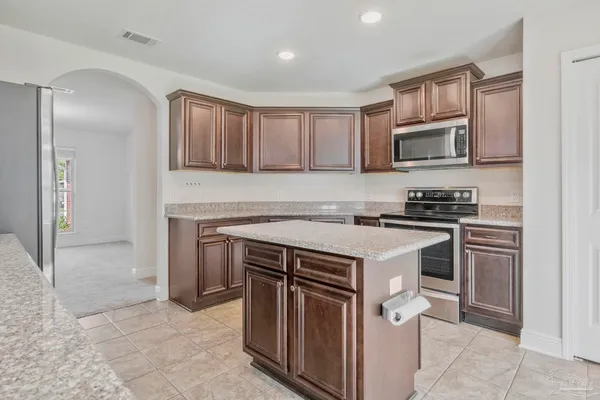 a kitchen with a stove sink and microwave