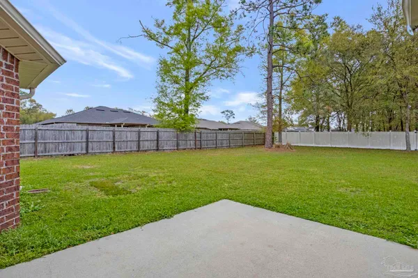 a view of a yard with a house in the background