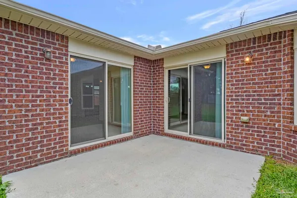 a view of a brick house with a large window