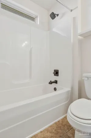a bathroom with a bathtub and a toilet