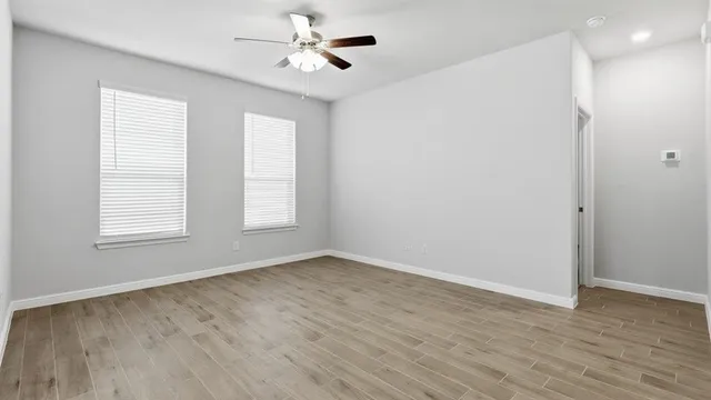 a kitchen with granite countertop white cabinets and stainless steel appliances