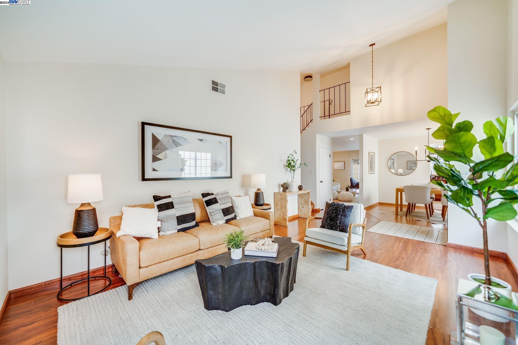 a living room with furniture and a potted plant